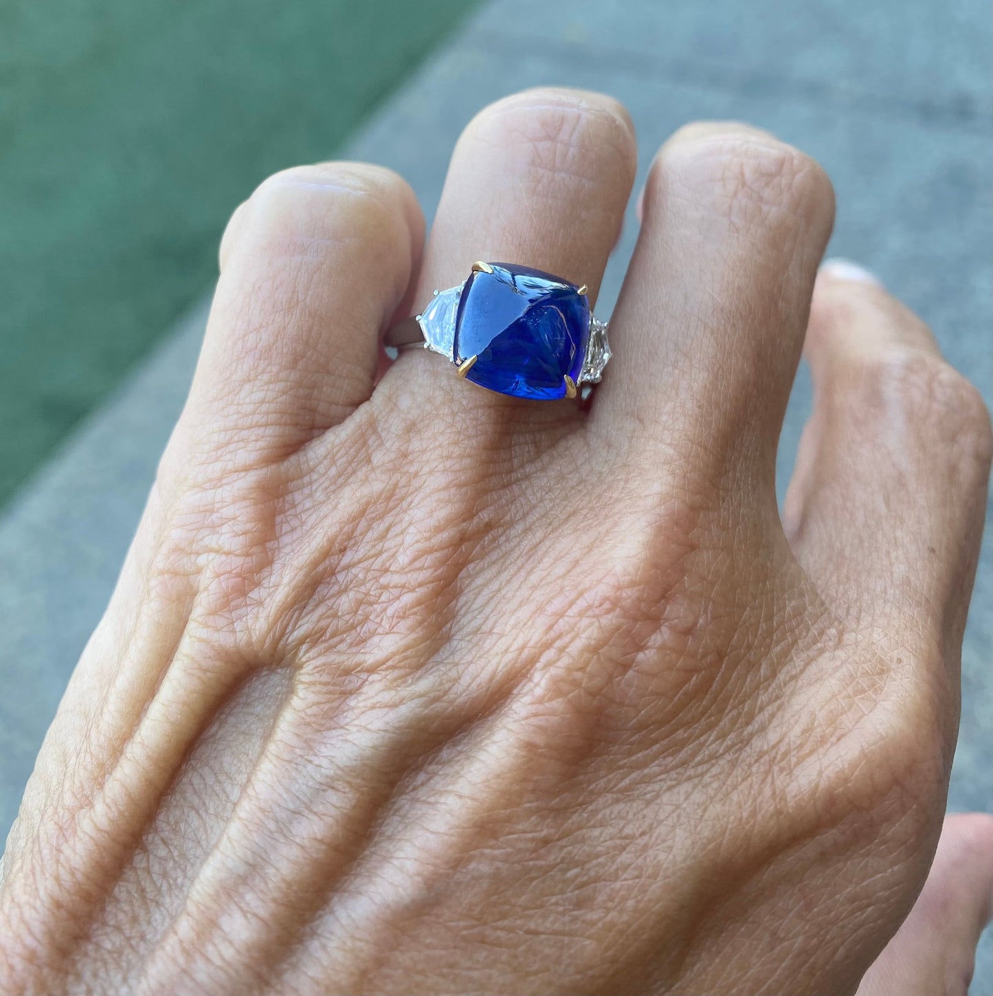 Adriatic Sea Sugarloaf Cabachon Blue Sapphire and 2 Cadillac Diamond Side Stones